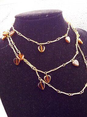 AMBER CRYSTAL HEARTS DANGLING FROM HORSEBIT ROSE GOLDEN 38" L. CHAIN 21